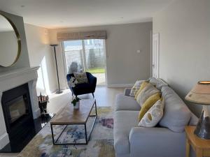 a living room with a couch and a fireplace at 3 Bed in Doonbeg oc-ii15918 in Kilrush +3 photos