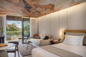 a bedroom with a bed and a living room at Dan Accadia Herzliya Hotel in Herzliya