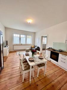 a kitchen and living room with a table and chairs at Ferienwohnung in Cammer +4 photos