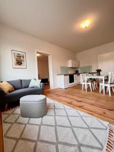 a living room with a blue couch and a table at Ferienwohnung in Cammer