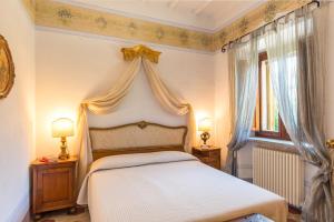 a bedroom with a white bed with a canopy at Antica Filanda Sunshine in Arezzo +32 photos