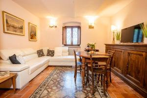 a living room with a white couch and a table at Antica Filanda Sunshine in Arezzo