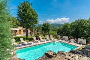 a swimming pool with chaise lounges and chairs at Antica Filanda Sunshine in Arezzo