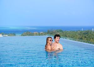 a man and a woman standing in the water at h78 Guraidhoo in Guraidhoo