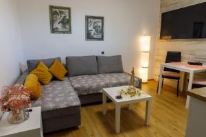 a living room with a couch and a table at Vila Rajska ptica in Bled