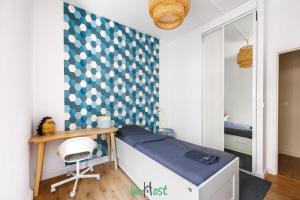 a small bedroom with a bed and a desk at Grand T5 lumineux au cœur de Besançon in Besançon +7 photos