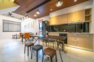 a large kitchen with a table and chairs in it at 仰森水畔 in Jiaoxi