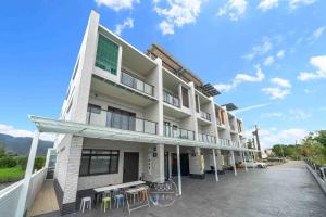 a building with tables and chairs in a parking lot at 仰森水畔 in Jiaoxi