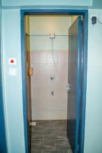 a bathroom with a shower with a glass door at Norlan Homes Kisumu in Kisumu