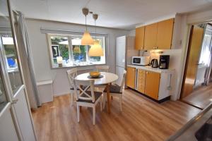 a kitchen and dining room with a table and chairs at "Lönnebo" in Lönneberga