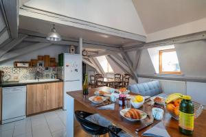a kitchen with a table with food on it at Le Nid Alsacien - Centre Ville - Proche Parking Gratuit - Europa-park in Erstein +17 photos