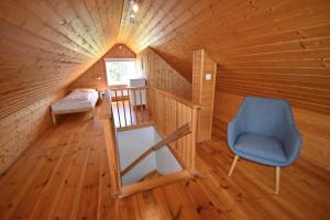 a room with a staircase and a blue chair at "Lönnebo" in Lönneberga