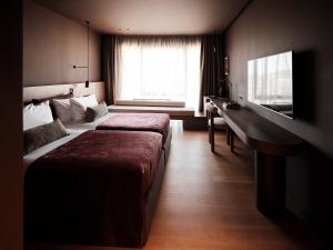 a hotel room with two beds and a desk at The Fiction in Athens +35 photos