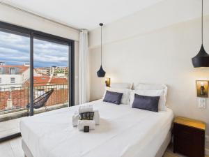 a bedroom with a large white bed and a large window at Residence Provencal - Luxurious - 300m Palais - LRA CANNES in Cannes +52 photos