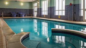 a swimming pool with blue water in a building at Barony Castle Hotel in Peebles