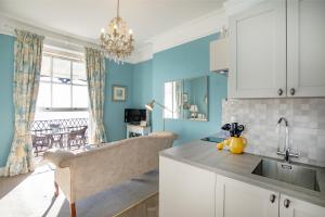 a kitchen with a sink and a counter top at Mariners Balcony Apartment in Sidmouth