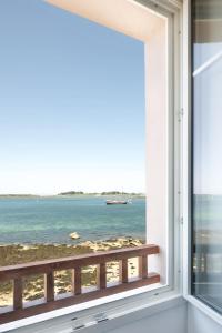 a window with a view of the ocean at ILE STAGADON - Appartement de luxe magnifique vue mer in Landéda