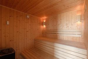a wooden sauna with two benches in a room at TY KOREJOU - splendide maison avec sauna les pieds dans l'eau in Plouguerneau