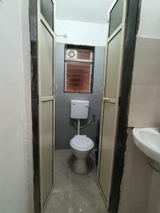 a bathroom with a toilet and a sink at Dapolihideaway in Dapoli +16 photos