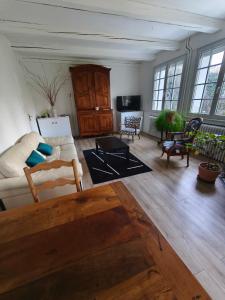 a living room with a couch and a table at LES VOLETS BLEUS in Metz
