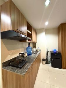 a kitchen with a stove and a counter top at The Midpoint Residences - Studio Unit in Cebu City