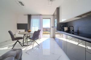 a kitchen with a table and chairs in a room at Luxury-relax residence Muraj in Kornić