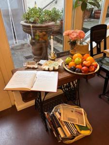 a table with a plate of fruit and a candle at Hotel Lux in Regensburg