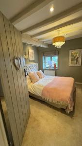 a bedroom with a large bed in a room at Spenford House 1640 listed house Idilic Location pub walking distance in Shrewsbury