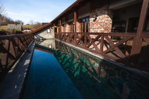 a swimming pool with a wooden fence around a house at Starý Svět in Wotitz