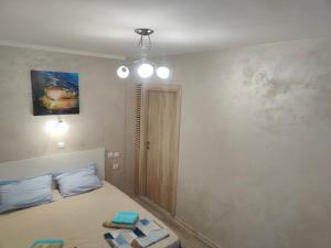 a bedroom with a bed with blue pillows on it at Лукс Апартамент Морска Перла in Primorsko +21 photos