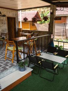 an outdoor patio with a table and chairs and a table and chairs at Mukda in Ko Yao Noi