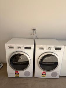 two washing machines sitting next to each other at Monash Ensuite room with shared kitchen & laundry in Oakleigh East