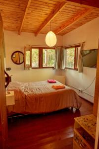 a bedroom with a bed in a room with windows at Cabaña Viedma in Viedma +16 photos