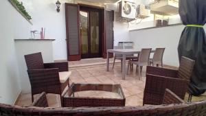 a patio with a table and chairs and a table and a table and chairs at terrazza acquaviva in Marittima