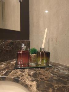 a bathroom counter with a sink with candles on it at Flat Luxo 3010 com banheira Mountain Village Laje de Pedra Canela in Canela +18 photos