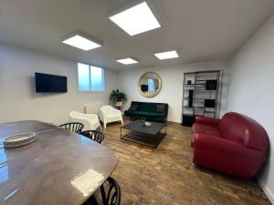 a living room with a table and a couch at Le Lido Maison 6 personnes in Saint-Varent