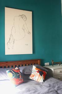 a bedroom with a drawing on the wall next to a bed at Casa Ruby in Huércal-Overa