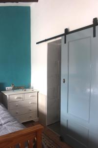 a bedroom with a white closet and a bed and a dresser at Casa Ruby in Huércal-Overa +14 photos