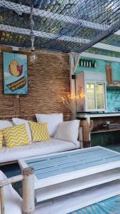 a living room with a couch and a table at La Demeure du Figuier in Évran