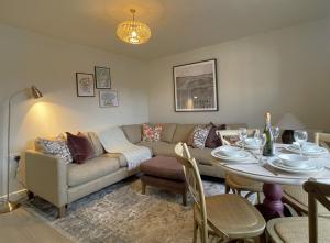 a living room with a couch and a table at Catbells in Keswick