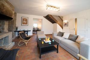 a living room with a couch and a table at AR PENNITI - Magnifique maison en pierre proche plage in Landéda