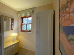 a bedroom with a door and a window at Catbells in Keswick
