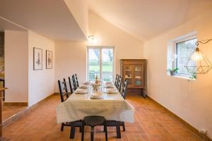 a dining room with a long table and chairs at AR PENNITI - Magnifique maison en pierre proche plage in Landéda
