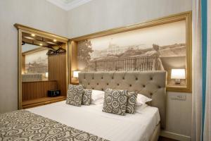 a bedroom with a bed with a picture on the wall at Hotel Della Torre Argentina in Rome +66 photos