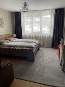 a bedroom with a bed and a large window at Casa Crăciun in Mănăstirea Humorului