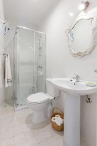 a bathroom with a toilet and a sink and a shower at Garden view in Cascais