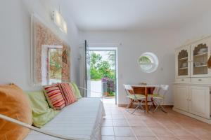 a living room with a couch and a table at Garden view in Cascais