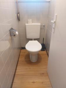a bathroom with a white toilet in a stall at Hôtel Garni Inter-Alp in Saint-Maurice +47 photos