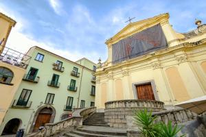 a building with stairs in front of two buildings at Luxury Apartment Salerno Center in Salerno