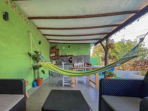 a patio with a hammock in the middle of a room at GuestReady - El Pinar isla del Hierro in El Pinar del Hierro